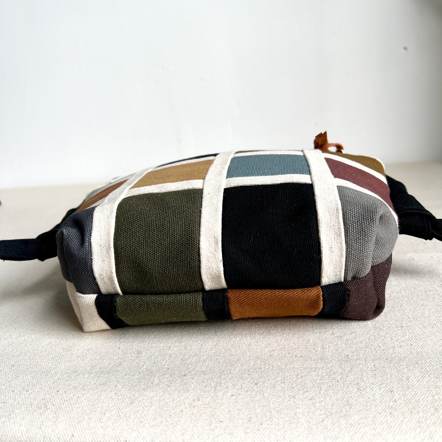 double-sided grid bag, natural and muted shades/ black with and muted shades