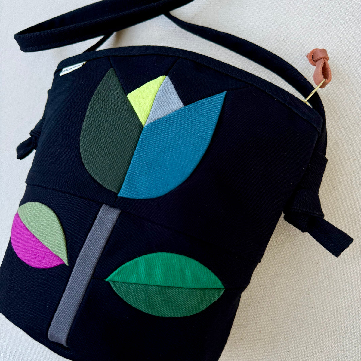 The Emmy Crossbody, pieced work tulip in black with turquoise/jade/raspberry etc