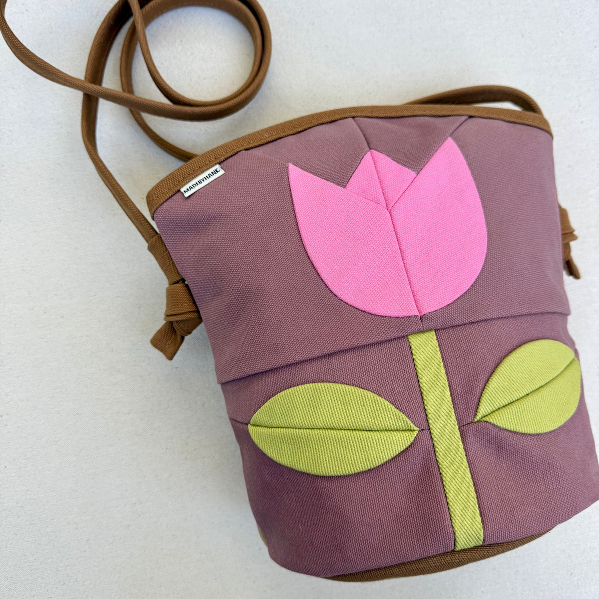 The Emmy Crossbody, pieced work tulip in mauve with flamingo pink and celery