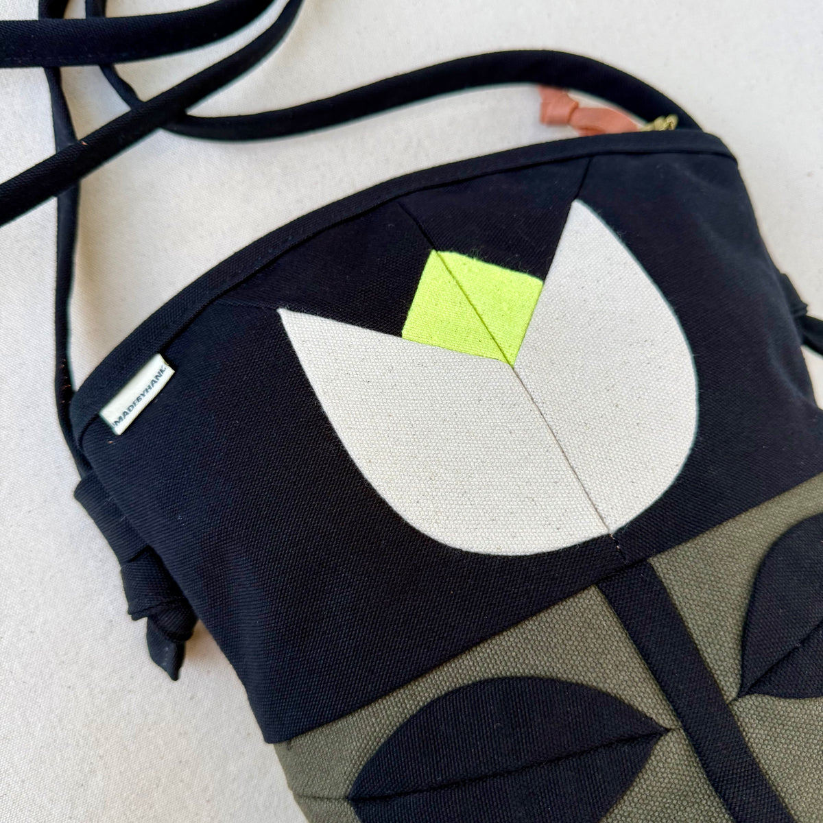 The Emmy Crossbody, pieced work tulip in dark olive/black/natural/neon
