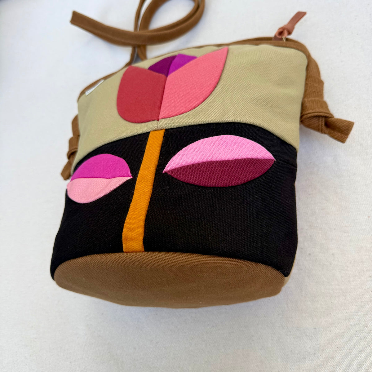The Emmy Crossbody, pieced work tulip in honey and espresso with pinks