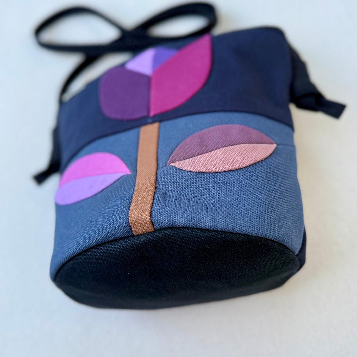 The Emmy Crossbody, pieced work tulip in midnight and dusk blue with purples+mauves