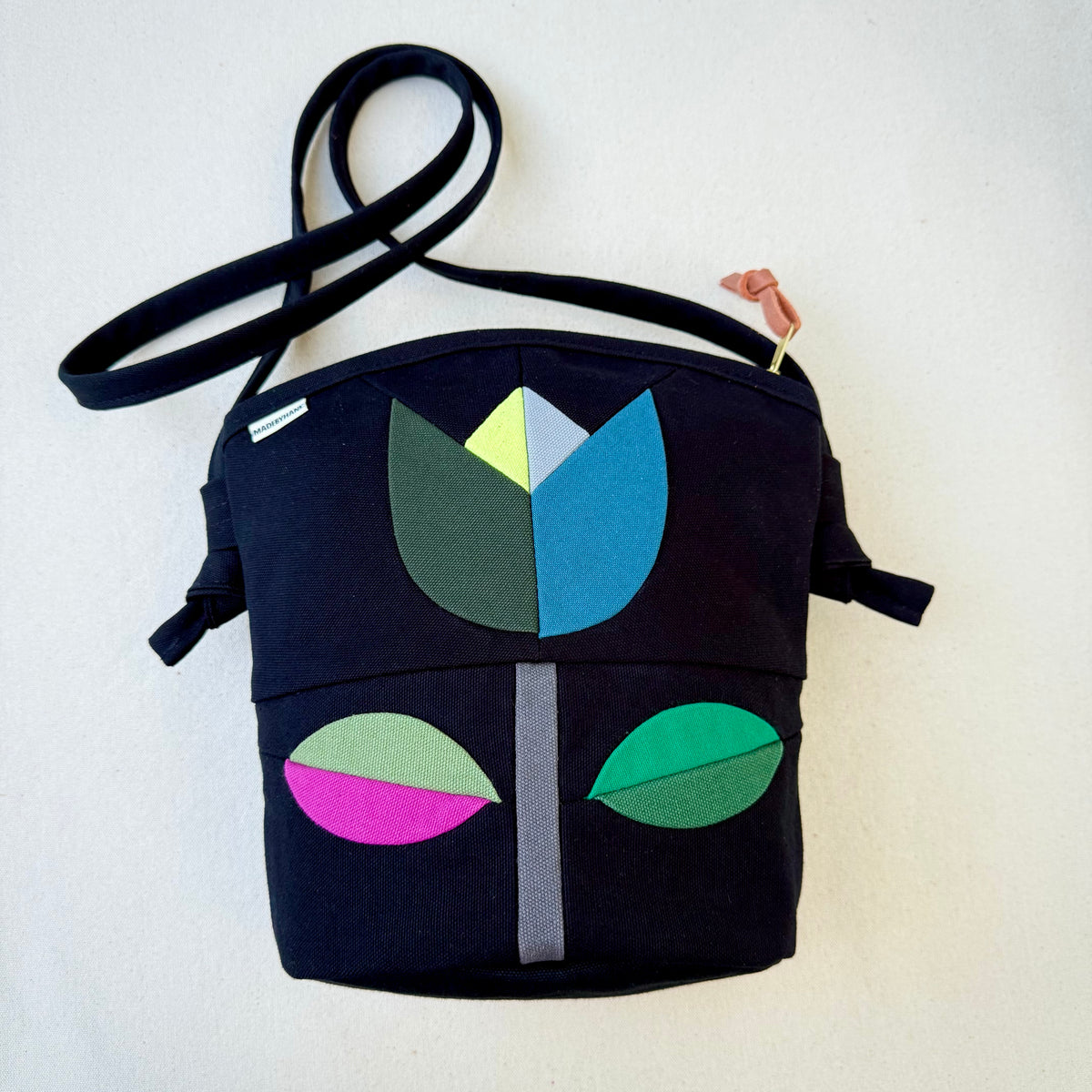 The Emmy Crossbody, pieced work tulip in black with turquoise/jade/raspberry etc