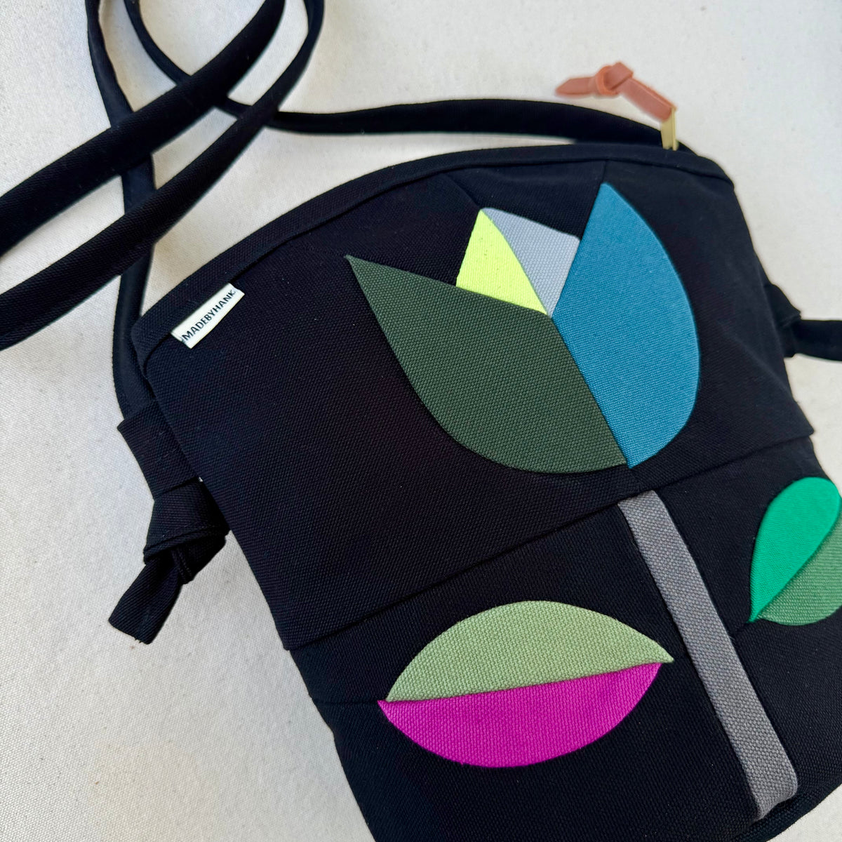 The Emmy Crossbody, pieced work tulip in black with turquoise/jade/raspberry etc