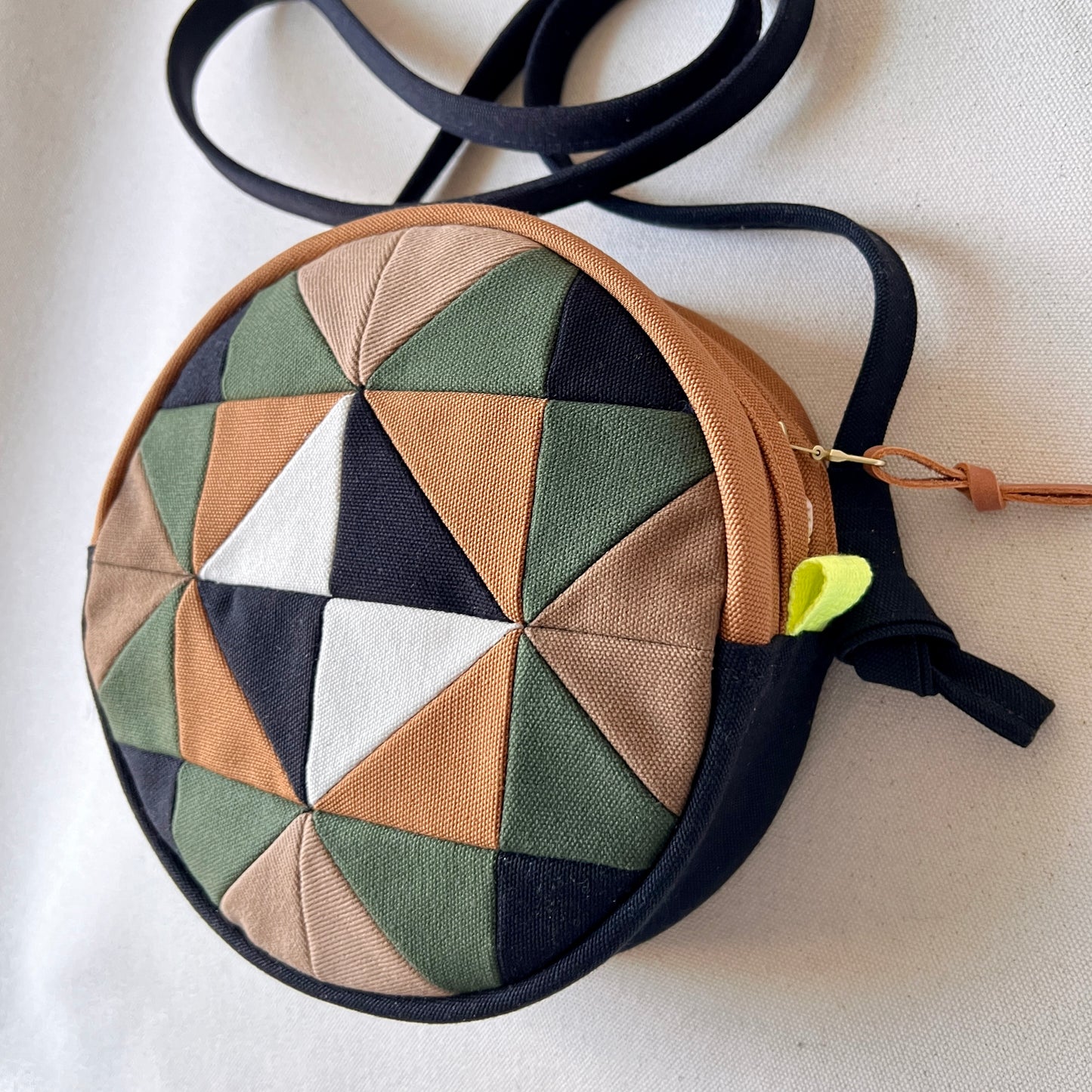 circle crossbody, caramel/sand/forest/black/natural with hints of neon green