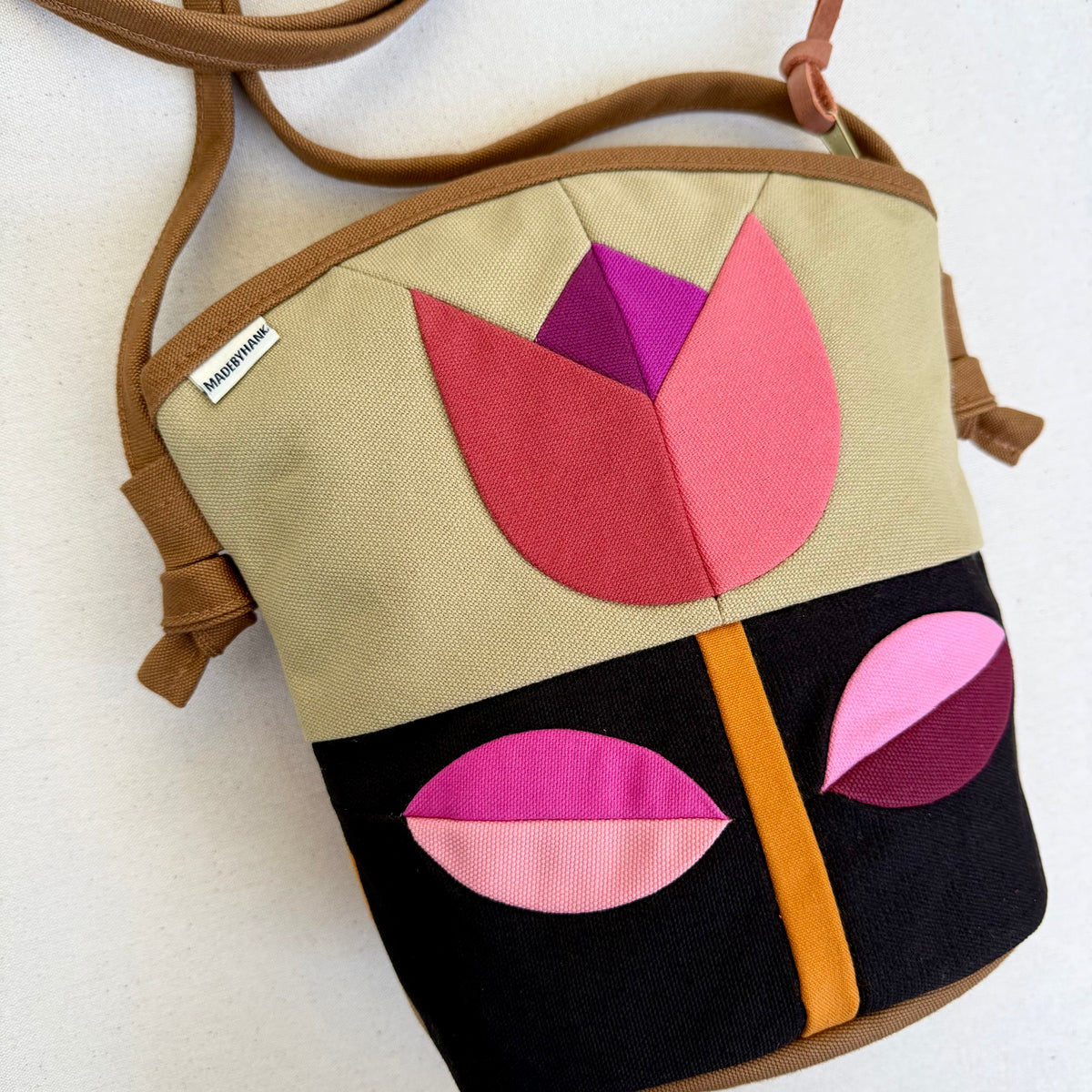The Emmy Crossbody, pieced work tulip in honey and espresso with pinks