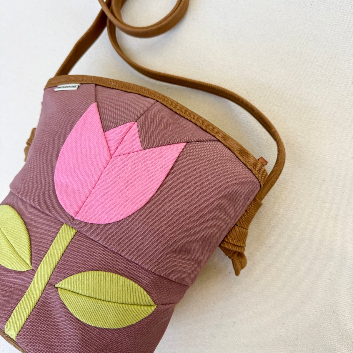 The Emmy Crossbody, pieced work tulip in mauve with flamingo pink and celery