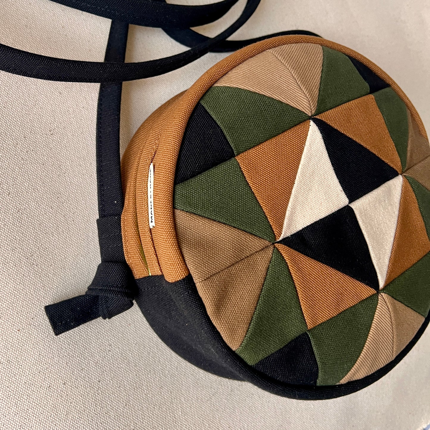 circle crossbody, caramel/sand/forest/black/natural with hints of neon green