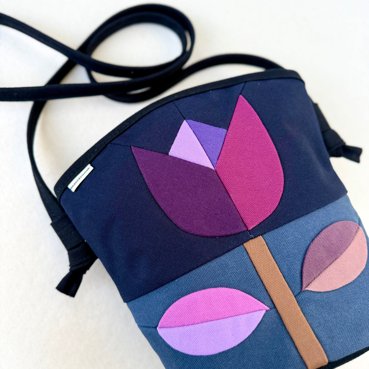 The Emmy Crossbody, pieced work tulip in midnight and dusk blue with purples+mauves