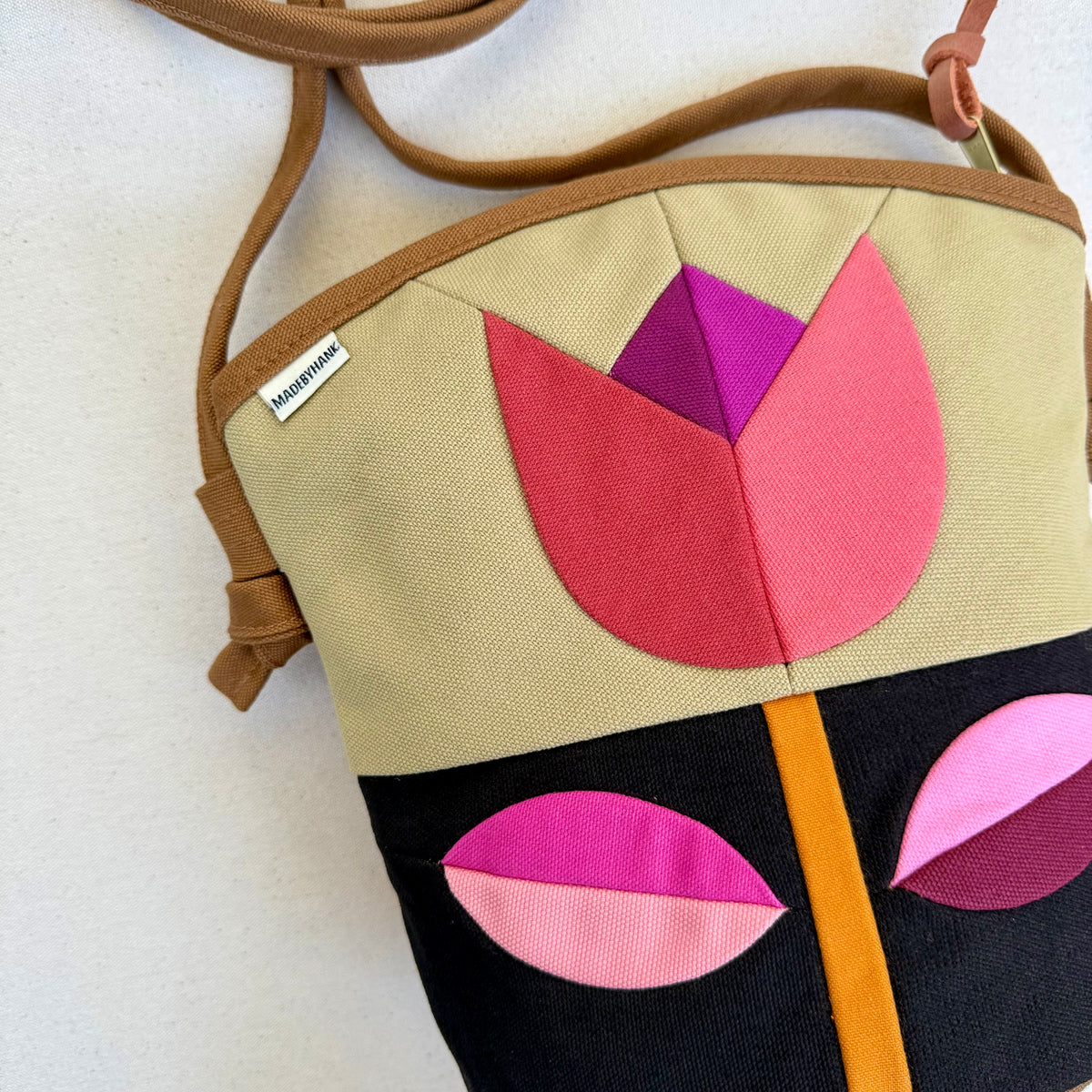 The Emmy Crossbody, pieced work tulip in honey and espresso with pinks