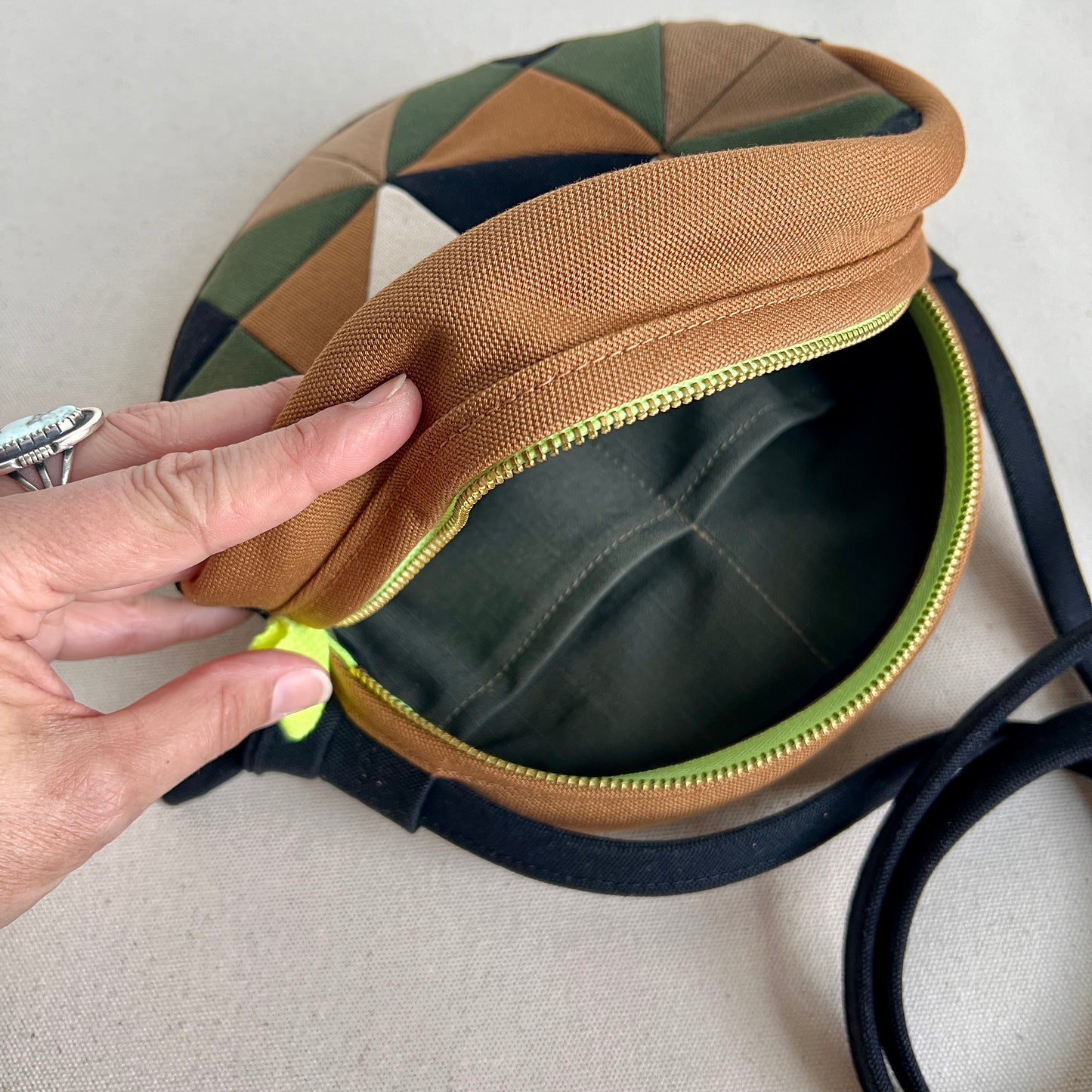 circle crossbody, caramel/sand/forest/black/natural with hints of neon green