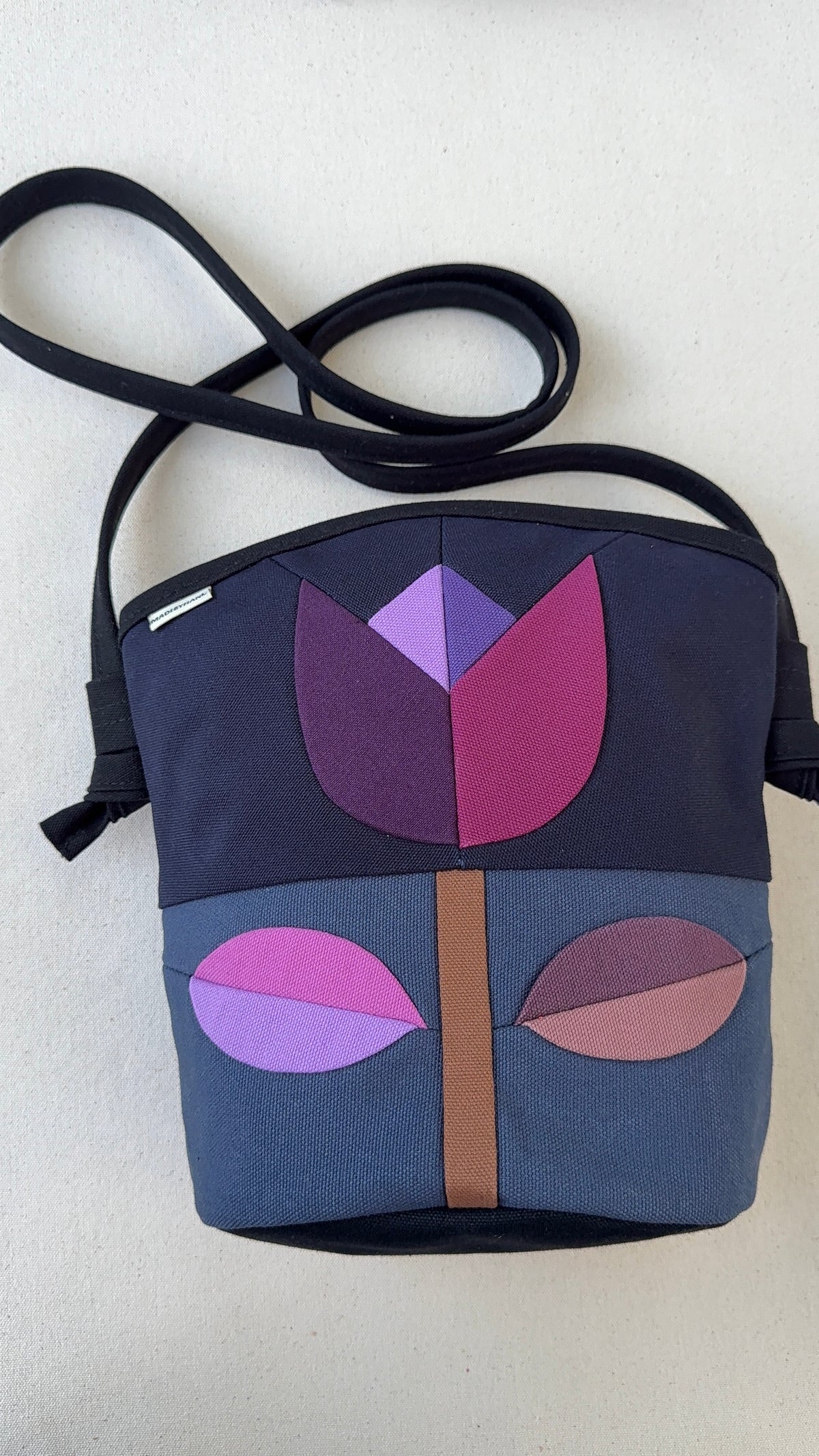 The Emmy Crossbody, pieced work tulip in midnight and dusk blue with purples+mauves