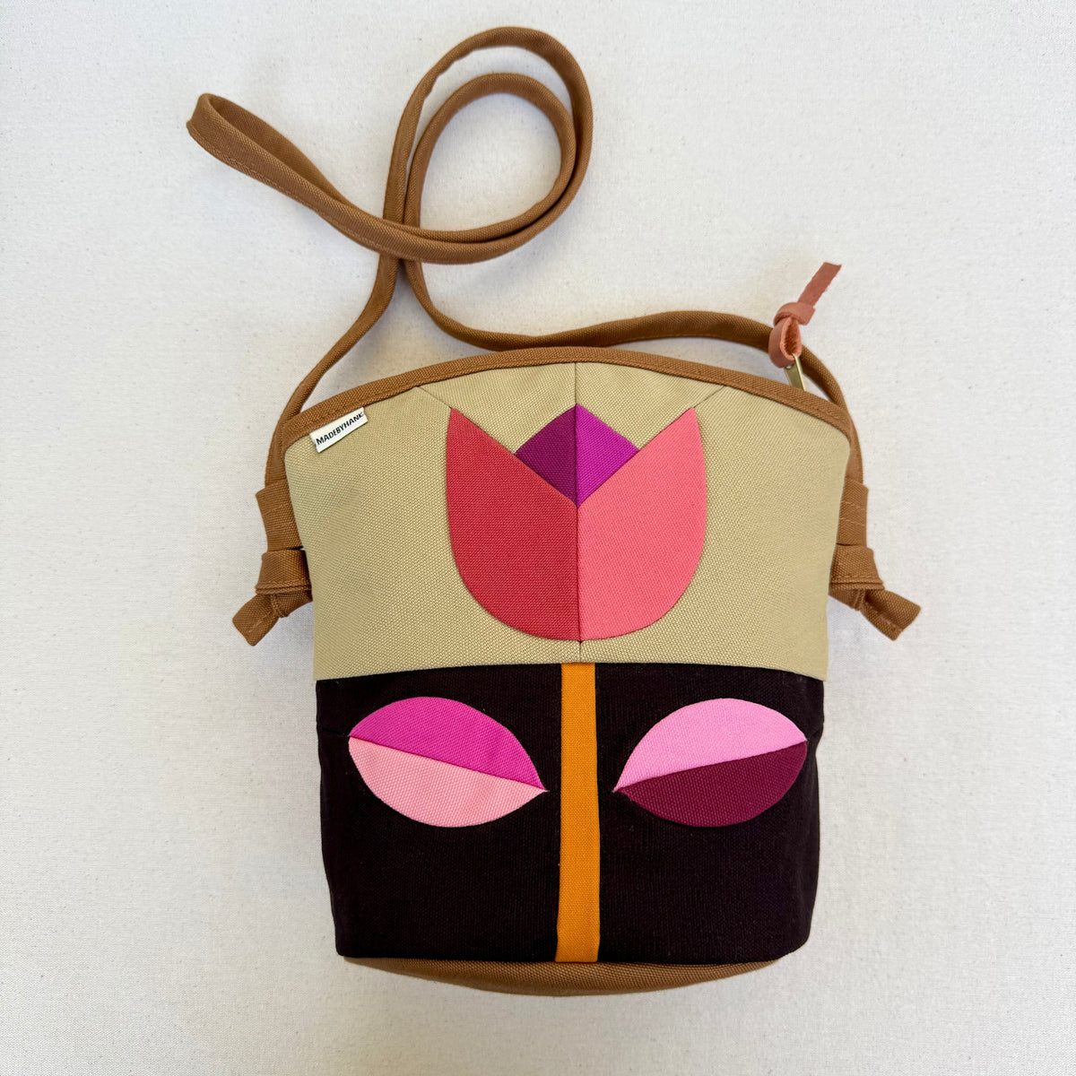 The Emmy Crossbody, pieced work tulip in honey and espresso with pinks
