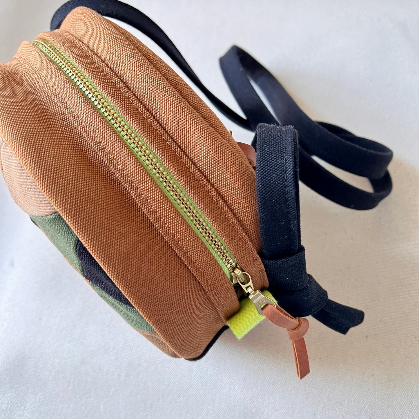 circle crossbody, caramel/sand/forest/black/natural with hints of neon green